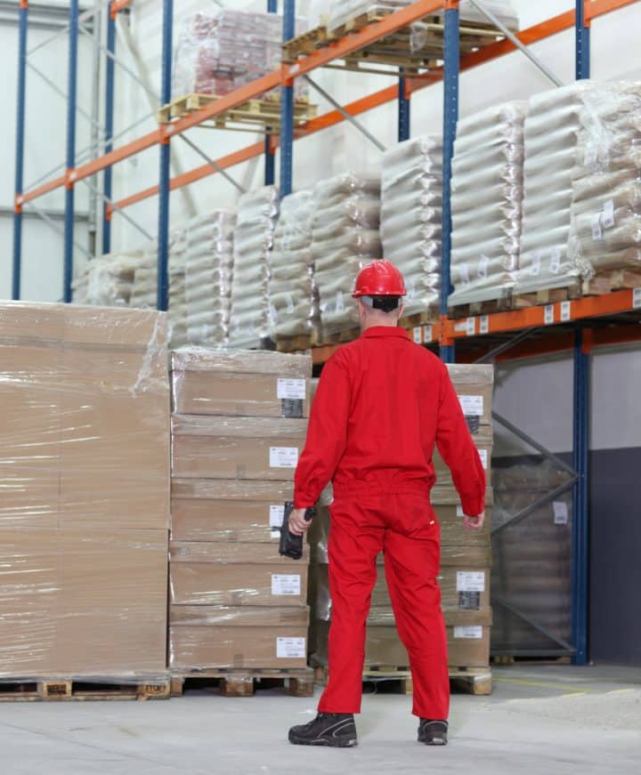 Worker in red standing in warehouse